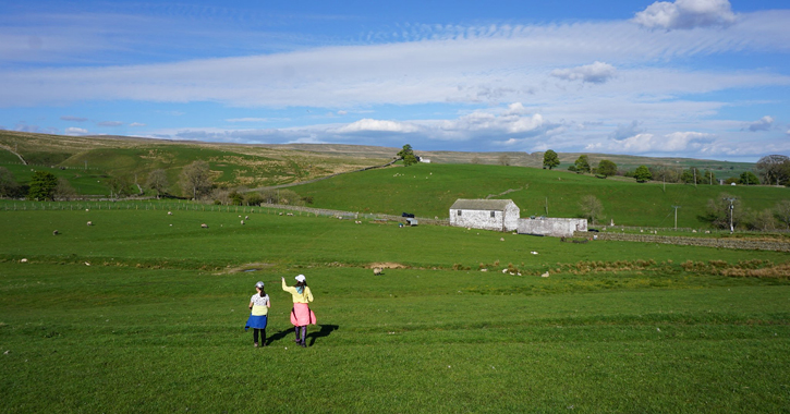 Children walking through fields in Teesdale, County Durham. 